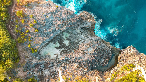 Drone shot of the natural pool Angel Billabong in Nusa Penida, Bali, Indonesia