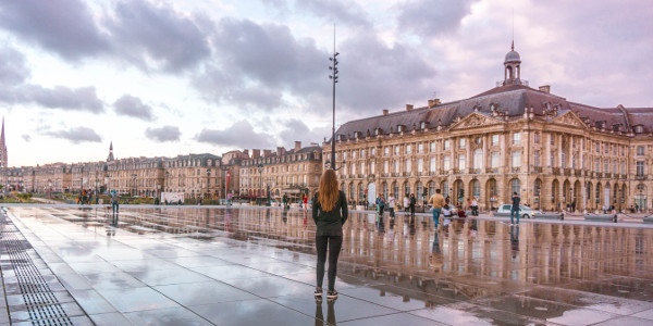 Reflection at Miroir d'Eau during sunset in Bordeaux, France